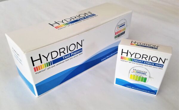 A box of hydrion test powder next to a container.