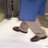 Person walks through white foam.