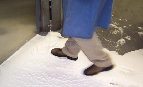 Person walks through white foam.