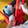 Cleaning supplies in a red cart.